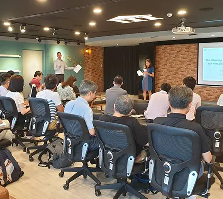 Troy Abbey presenting during a workshop to a seated group.